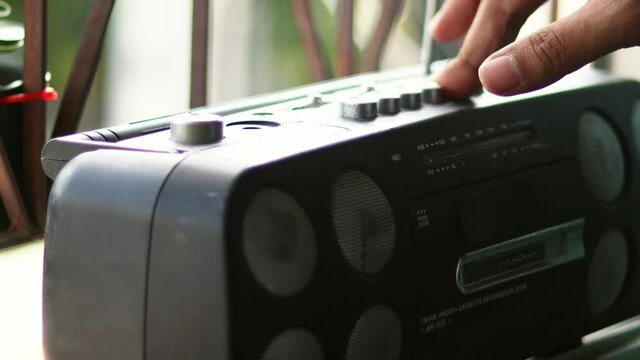  Close Up hand with mustache and mullet from the 70s 80s 90 listens to his music using a portable walkman cassette player. Vintage concept.