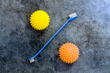an unusual and interesting percentage sign made of a dog toothbrush and two balls for washing clothes in a typewriter; a crazy design solution