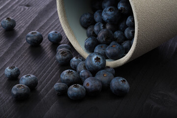 Close up of a blueberries on a wood table.