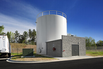 Modern utilities building and white storage silo container