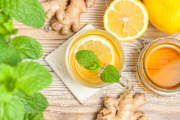 Cup of tea with lemon, ginger root and mint leaf