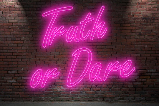 Neon erotic game Truth or Dare (in german Wahrheit oder Pflicht) lettering on Brick Wall at night