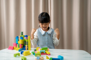 Happy girl children play with colorful plastic toy blocks,Educational toys.