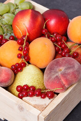 Heap of fruits in wooden box as healthy snack or dessert containing natural vitamins