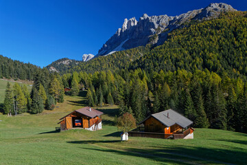Obraz premium Countryside landscape of farms and fileds among the mountains of Dolomites, Italy