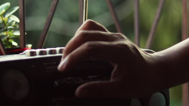  Close Up hand with mustache and mullet from the 70s 80s 90 listens to his music using a portable walkman cassette player. Vintage concept.