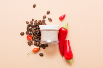 Natural cosmetic products with red chili peppers on a light beige background. Cosmetic jar mockup.