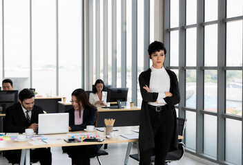 Business woman standing in office. Beautiful business woman who is smart, modern and up-to-date. Have a broad vision lead the organization to success. Business competition