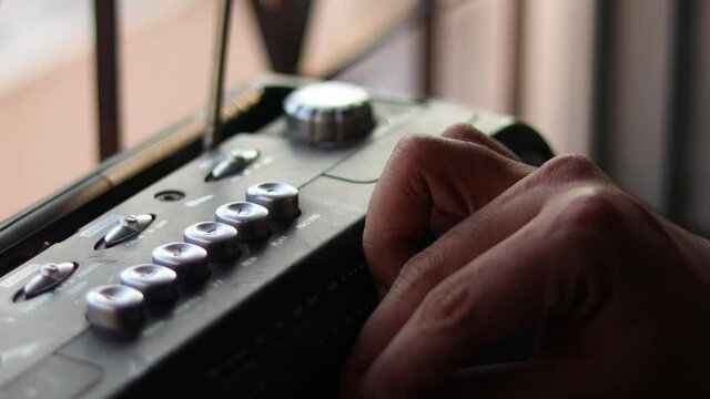  Close Up hand with mustache and mullet from the 70s 80s 90 listens to his music using a portable walkman cassette player. Vintage concept.