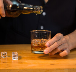Barman pouring whiskey whiskey glass beautiful night