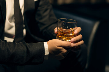 Businessmen in suits drinking whiskey