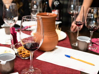 red grape wine tasting - wineglasses with tested wines and clay jug on table