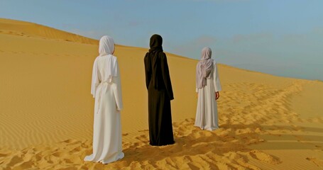 Three muslim women in the desert