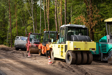 Fototapeta na wymiar Modern equipment and machines for making high-quality asphalt roads. Road construction