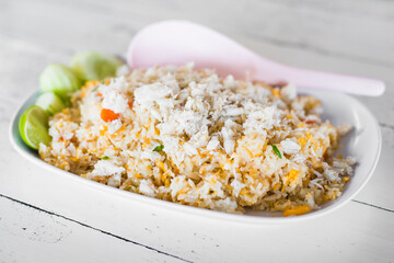 Thai food called Khao pad poo. Delicious Fried rice with crab condensed eggs on a wooden table.