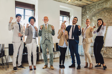 Fototapeta premium Happy business people celebrating success at company.
