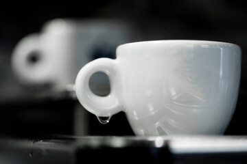 Coffee cup on a coffee machine at a coffee shop. Still details. High quality photo