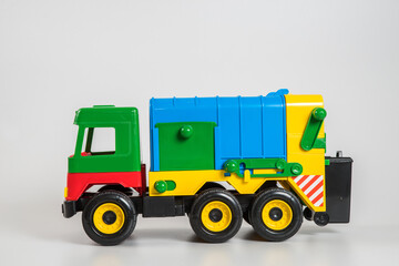 Naklejka premium Multi-colored plastic children's toy cars on a white background.