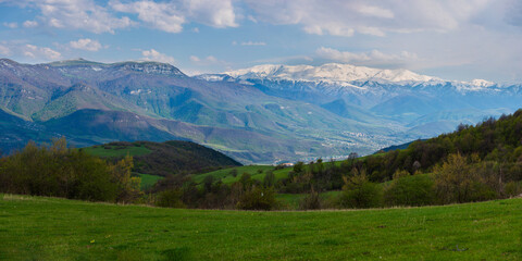 Panoramic view of the outskirts of Ijevan with snowy mountains and forest, Armenia