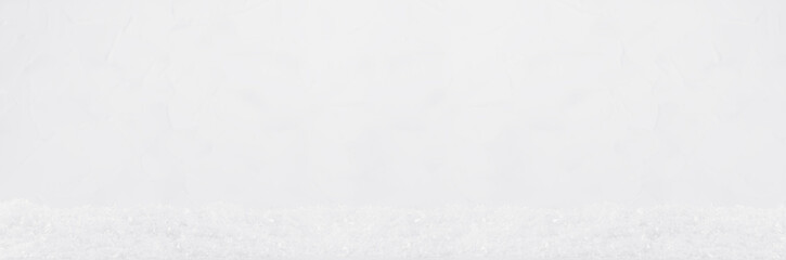 Sparkling bright white rouch fluffy fake snow with soft light .snowflakes as decorative fairy season winter banner. Festive blank christmas banner for design, website, header, presentation.