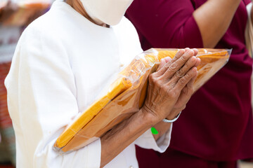 Buddhists holding robes to make merit