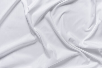 Abstract white fabric texture background. Cloth soft wave. Creases of satin, silk, and cotton.