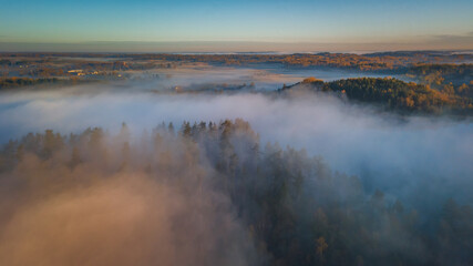 Aerial view of epic fog over the forests at Autumn