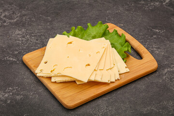 Sliced yellow cheese over board