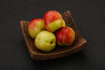 Sweet small nectarines in the basket