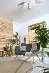 Comfortable sofa and beautiful houseplants in room. Lounge area interior