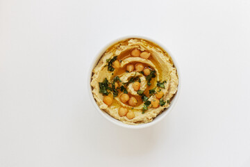 Hummus - chickpea traditional jewish and lebanese cuisine meal isolated on white background, flat lay, from above  top view, closeup, houmous is a vegan healthy legume food