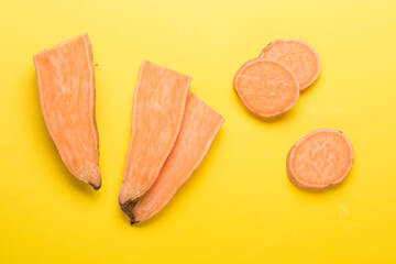 Sweet potato vegetable on a yellow background. Sliced ​​sweet potato. In the Cut.