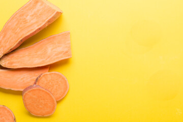 Sweet potato vegetable on a yellow background. Sliced ​​sweet potato. In the Cut.
