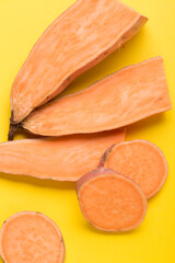 Sweet potato vegetable on a yellow background. Sliced ​​sweet potato. In the Cut.