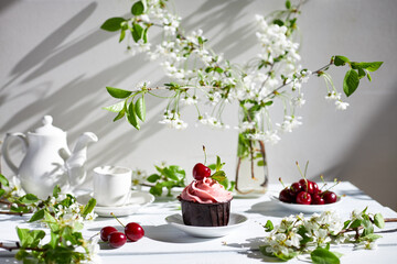 a small cupcake on the table with a beautiful cream. muffins