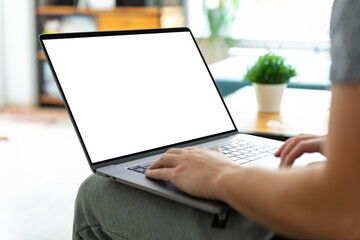 Man using laptop blank screen while sitting on sofa
