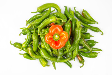 green hot peppers and red bell peppers on a white background. vitamin vegetables for health