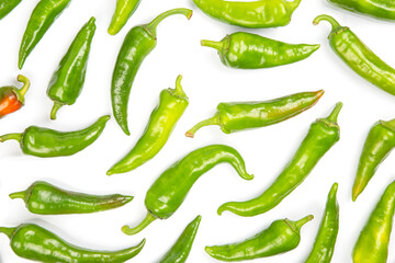 green hot peppers evenly spread on a white background. vitamin vegetables for health