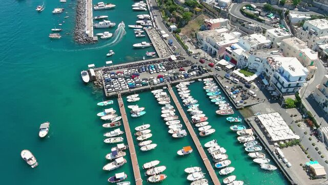 Capri, Italy: Aerial view of famous Italian island near Naples, north region Marina Grande, lot of boats and yachts around Porto Turistico di Capri - landscape panorama of Europe from above