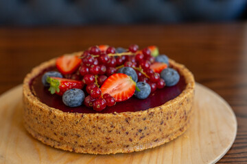 Fresh dietary dessert made of cow cream and frozen fruits and berries. Pie baked in oven. concept is vegetarian desserts.