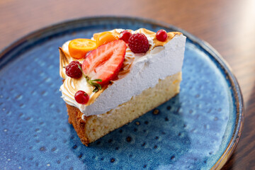 triangular piece of fresh diet dessert cake made of delicious cream and frozen fruits and berries. Raw food cake dessert. concept is vegetarian desserts.
