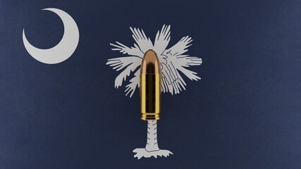 Top down view of a 9mm bullet in the center and on top of the US state flag of South Carolina