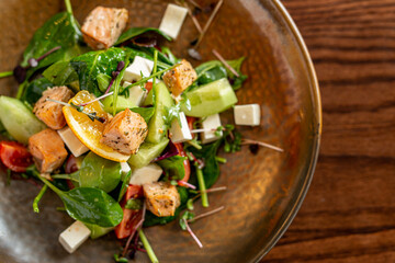 European Mediterranean salad of seasonal vegetables. Salad of tomatoes, cucumbers and fresh herbs with olive oil. Concept menu of summer cafe
