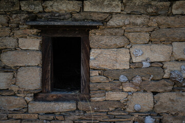 Fototapeta na wymiar Old ancient window frame in the wall of cement bricks. A window frame on the left with copyspace.