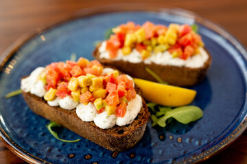 French bruschetta with cream cheese and thin sliced meat and baked vegetables.Concept menu of summer cafe