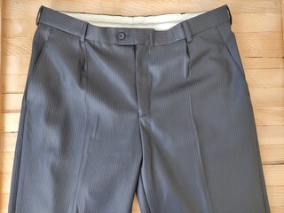 Classic trouser on the wooden background, close-up