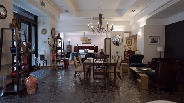 Wide shot expensive furnishings standing in store showroom indoors. Fashionable luxurious furniture shop with high-class furnishings. Live camera