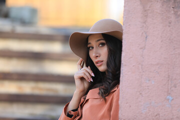 autumn portrait of a beautiful asian brunette woman in a fashionable hat