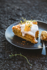 Traditional American pumpkin pie with whipped cream and cinnamon on dark table. top view