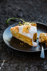 Traditional American pumpkin pie with whipped cream and cinnamon on dark table. top view